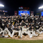
              The San Diego Padres celebrate as they pose for a team photo on the field after defeating the New York Mets in Game 3 of a National League wild-card baseball playoff series, Sunday, Oct. 9, 2022, in New York. (AP Photo/John Minchillo)
            