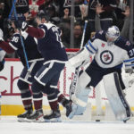 
              Winnipeg Jets goaltender Connor Hellebuyck, right, reacts after giving up a goal to Colorado Avalanche right wing Mikko Rantanen, left, who celebrates with right wing Valeri Nichushkin during the second period of an NHL hockey game Wednesday, Oct. 19, 2022, in Denver. (AP Photo/David Zalubowski)
            
