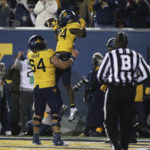 
              West Virginia offensive lineman Zach Frazier (54) and West Virginia running back Tony Mathis Jr. (24) celebrate Mathis' touchdown during the second half of the team's NCAA college football game against Baylor in Morgantown, W.Va., Thursday, Oct. 13, 2022. (AP Photo/Kathleen Batten)
            