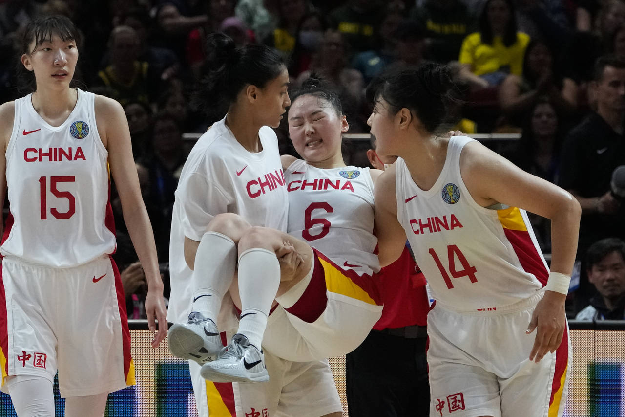 China's Wu Tongtong is carried from the court by teammates during their gold medal game at the wome...