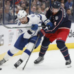 
              Columbus Blue Jackets' Vladislav Gavrikov, right, chases Tampa Bay Lightning's Erik Cernak behind the net during the first period of an NHL hockey game Friday, Oct. 14, 2022, in Columbus, Ohio. (AP Photo/Jay LaPrete)
            