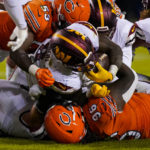 
              Washington Commanders running back Brian Robinson Jr. runs in for touchdown over Chicago Bears defensive lineman Armon Watts in the second half of an NFL football game in Chicago, Thursday, Oct. 13, 2022. (AP Photo/Nam Y. Huh)
            