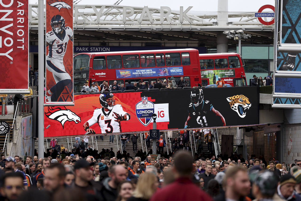 Football supporters arrive before the NFL football game between Denver Broncos and Jacksonville Jag...