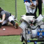 
              Toronto Blue Jays infielder Bo Bichette (11) fields a ball for a photograph before a baseball workout, Thursday, Oct. 6, 2022, in Toronto, ahead of the team's wildcard playoff game against the Seattle Mariners. (Alex Lupul/The Canadian Press via AP)
            