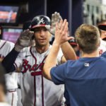 
              Atlanta Braves' Matt Olson high-fives teammates in the dugout after he hit a solo home run hit in the sixth inning of a baseball against the New York Mets, Sunday, Oct. 2, 2022, in Atlanta. (AP Photo/Hakim Wright Sr.)
            