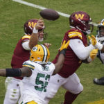 
              Washington Commanders quarterback Taylor Heinicke (4) throws under pressure from Green Bay Packers linebacker Rashan Gary (52) during the first half of an NFL football game Sunday, Oct. 23, 2022, in Landover, Md. (AP Photo/Al Drago)
            