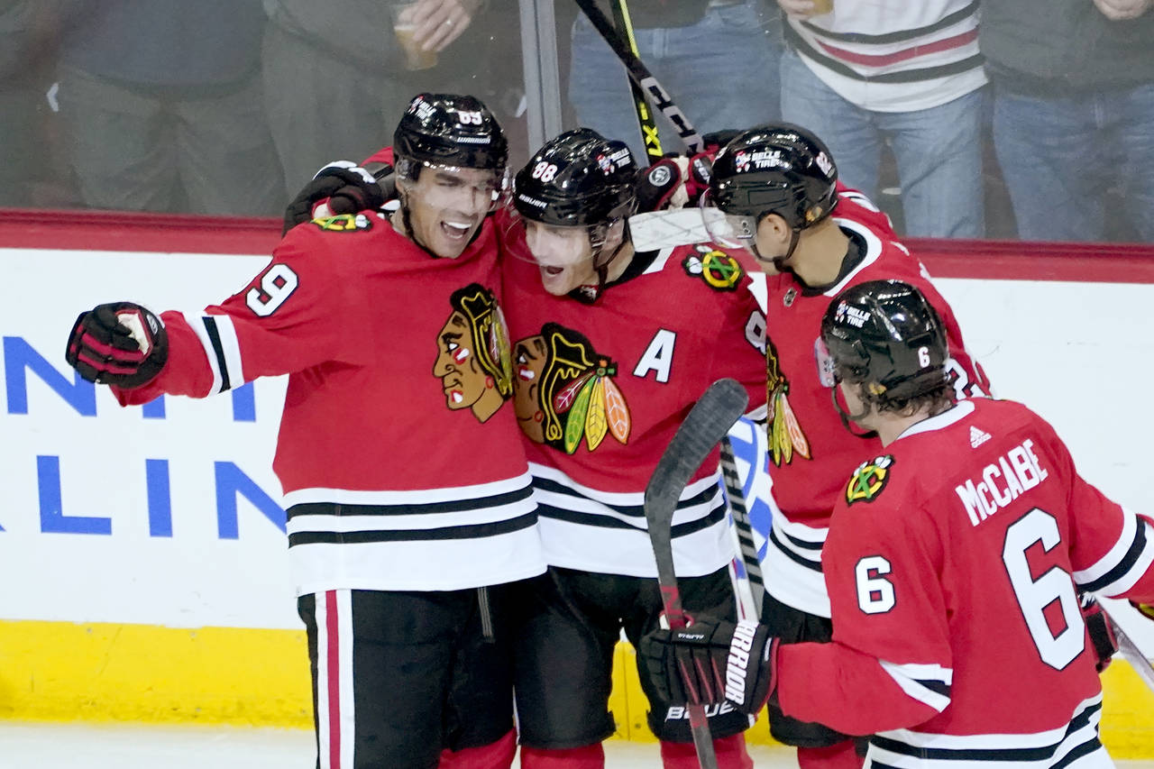 Chicago Blackhawks' Patrick Kane, second from left, celebrates his goal with Andreas Athanasiou (89...