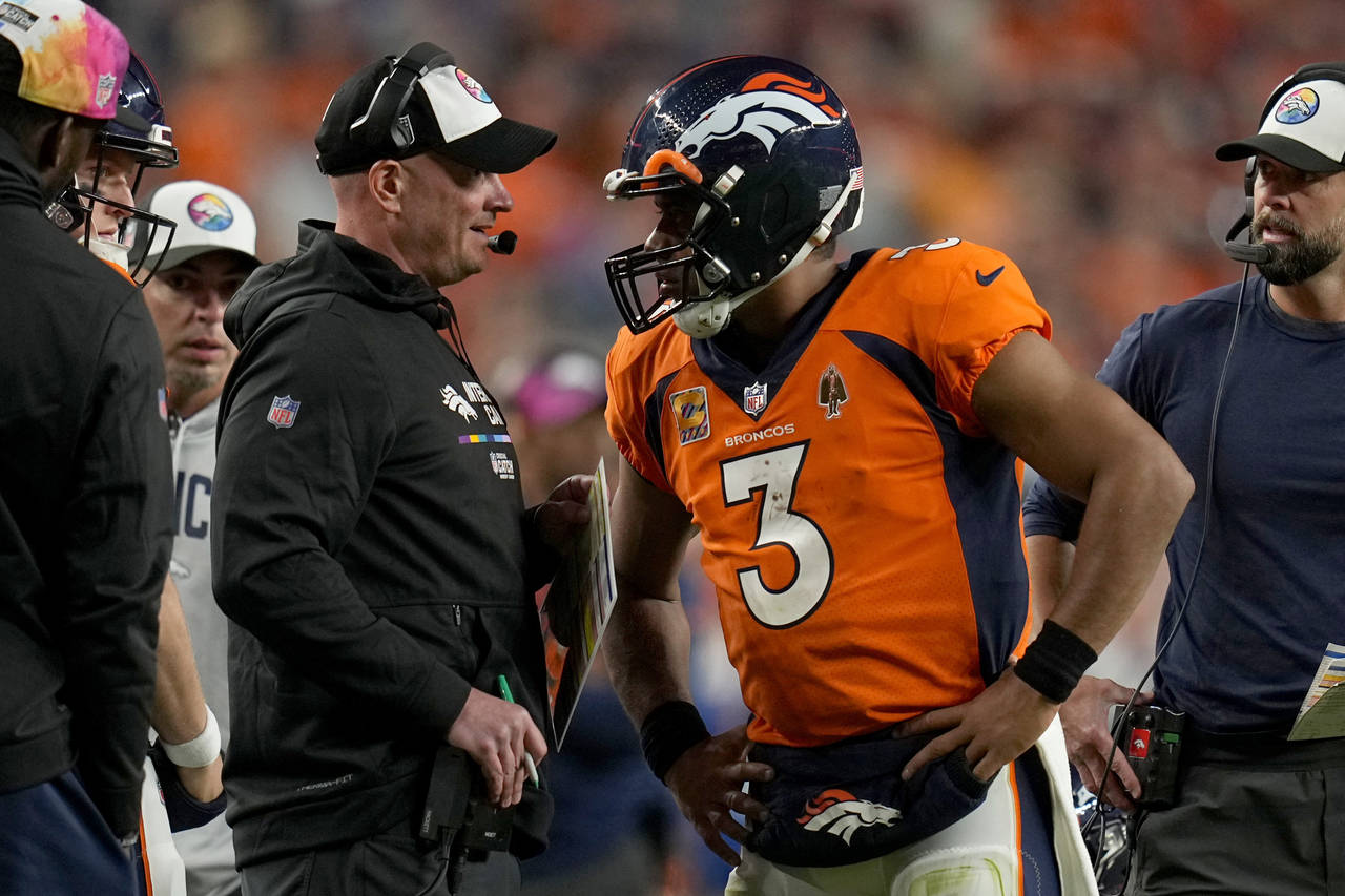 Denver Broncos quarterback Russell Wilson (3) talks with head coach Nathaniel Hackett during the se...