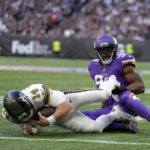 
              New Orleans Saints quarterback Andy Dalton (14) is tackled just short of the end zone during an NFL match between Minnesota Vikings and New Orleans Saints at the Tottenham Hotspur stadium in London, Sunday, Oct. 2, 2022. (AP Photo/Kirsty Wigglesworth)
            