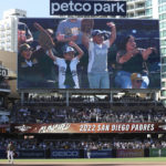 
              San Diego Padres' fans celebrate on the scoreboard after the team clinched a playoff berth during the eighth inning of a baseball game against the Chicago White Sox Sunday, Oct. 2, 2022, in San Diego. (AP Photo/Derrick Tuskan)
            