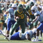 
              Baylor running back Richard Reese runs through the Kansas defense in the first half of an NCAA college football game, Saturday, Oct. 22, 2022, in Waco, Texas. (AP Photo/Jerry Larson)
            