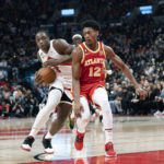 
              Toronto Raptors forward O.G. Anunoby (3) pushes against Atlanta Hawks forward De'Andre Hunter (12) during the first half of an NBA basketball game in Toronto on Monday, Oct. 31, 2022. (Arlyn McAdorey/The Canadian Press via AP)
            