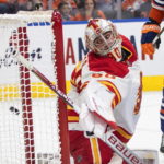 
              Calgary Flames goalie Dan Vladar gives up a goal to the Edmonton Oilers during the second period of an NHL hockey game Saturday, Oct. 15, 2022, in Edmonton, Alberta. (Jason Franson/The Canadian Press via AP)
            