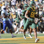 
              Baylor wide receiver Monaray Baldwin scores a touchdown against Kansas in the first half of an NCAA college football game, Saturday, Oct. 22, 2022, in Waco, Texas. (AP Photo/Jerry Larson)
            