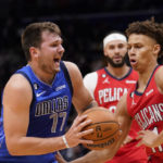 
              Dallas Mavericks guard Luka Doncic (77) drives to the basket against New Orleans Pelicans guard Dyson Daniels in the first half of an NBA basketball game in New Orleans, Tuesday, Oct. 25, 2022. (AP Photo/Gerald Herbert)
            
