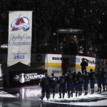 
              Members of the Colorado Avalanche look at the championship banner before it was lifted into the arena rafters before the team's NHL hockey game against the Chicago Blackhawks on Wednesday, Oct. 12, 2022, in Denver. (AP Photo/Jack Dempsey)
            