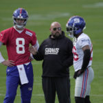 
              From left, New York Giants quarterback Daniel Jones, number 8, head coach Brian Daboll and running back Saquon Barkley, number 26, attend a practice session at Hanbury Manor in Ware, England, Friday, Oct. 7, 2022 ahead the NFL game against Green Bay Packers at the Tottenham Hotspur stadium on Sunday. (AP Photo/Kin Cheung)
            