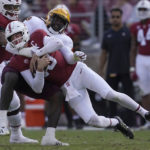 
              Stanford quarterback Tanner McKee, bottom, is tackled by Arizona State defensive lineman Travez Moore during the second half of an NCAA college football game in Stanford, Calif., Saturday, Oct. 22, 2022. (AP Photo/Jeff Chiu)
            