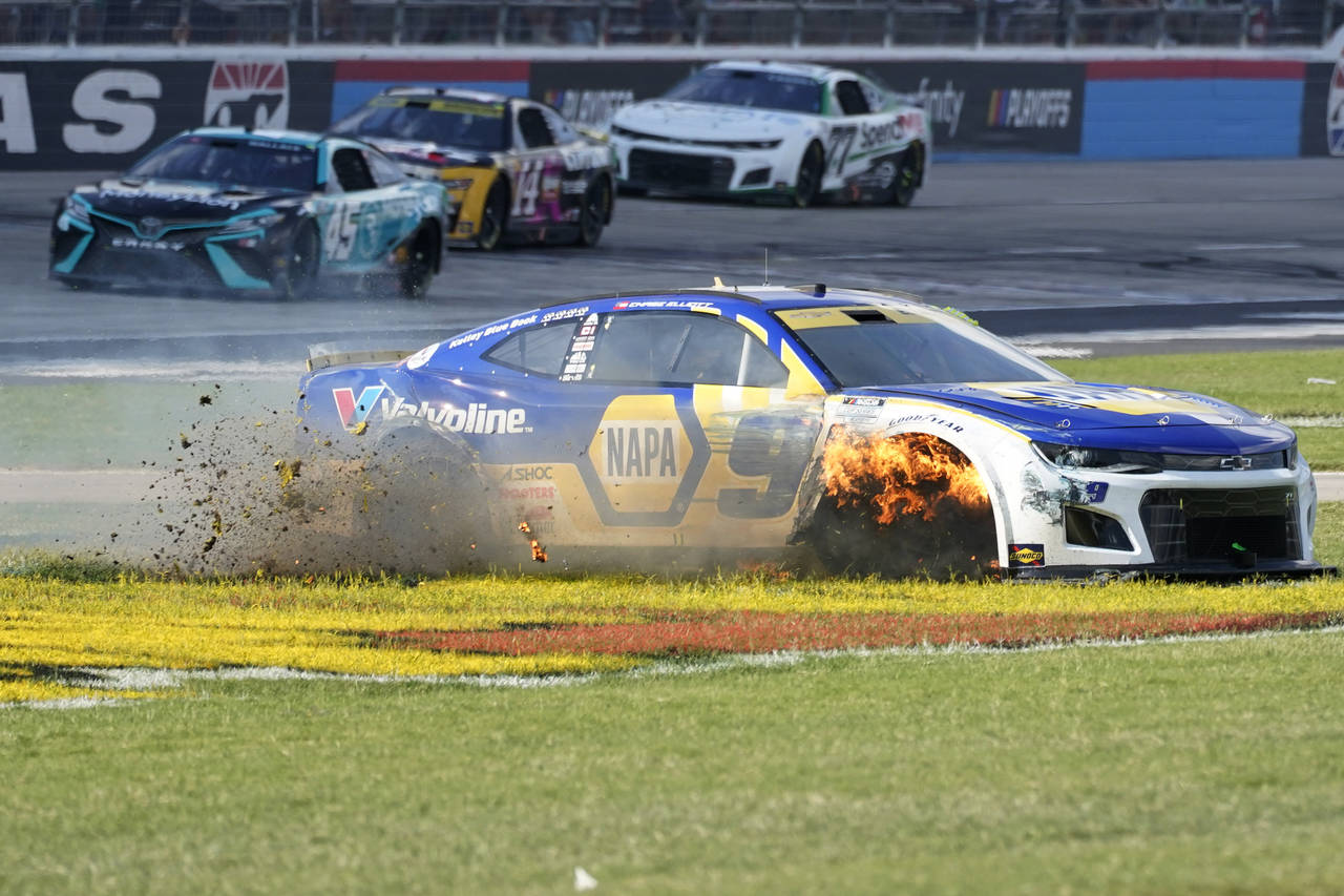 Chase Elliott's tire burns as he slides in the grass after he contacted the wall during the NASCAR ...