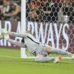 
              FILE - Australia goalkeeper Andrew Redmayne saves during a penalty shoot out during the World Cup 2022 qualifying play-off soccer match between Australia and Peru in Al Rayyan, Qatar on June 13, 2022. (AP Photo/Hussein Sayed, File)
            