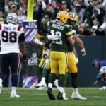 
              Green Bay Packers quarterback Aaron Rodgers (12) celebrates with teammate offensive tackle David Bakhtiari after throwing a touchdown pass during the second half of an NFL football game against the New England Patriots, Sunday, Oct. 2, 2022, in Green Bay, Wis. (AP Photo/Morry Gash)
            