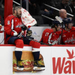 
              Washington Capitals left wing Alex Ovechkin (8) wipes his face during a break in the first period of the team's NHL hockey game against the Boston Bruins, Wednesday, Oct. 12, 2022, in Washington. (AP Photo/Nick Wass)
            