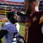 
              Tennessee Titans linebacker David Long Jr., left, speaks with Washington Commanders quarterback Carson Wentz after an NFL football game, Sunday, Oct. 9, 2022, in Landover, Md. Long intercepted a pass attempt by Wentz at the 1-yard line in the final moments of the game, and Tennessee won 21-17. (AP Photo/Alex Brandon)
            