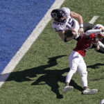 
              TCU quarterback Max Duggan (15) is upended by Kansas cornerback Cobee Bryant (2) during the first half of an NCAA college football game Saturday, Oct. 8, 2022, in Lawrence, Kan. (AP Photo/Charlie Riedel)
            