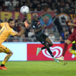 
              Napoli's Victor Osimhen, center, scores his side's opening goal during a Serie A soccer match between Roma and Napoli, at the Olimpic stadium in Rome, Sunday, Oct. 23, 2022. (AP Photo/Andrew Medichini)
            