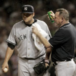 
              FILE - New York Yankee head trainer Gene Monahan sprays New York Yankees pitcher Joba Chamberlain with bug spray as small insects swarm in the eighth inning of Game 2 of an American League Division Series baseball game against the Cleveland Indians, Friday, Oct. 5, 2007, in Cleveland. Their fans still bugged by what happened in 2007, the New York Yankees could face those pesky midges again when the American League Division Series returns to Cleveland this weekend. (AP Photo/Amy Sancetta, File)
            