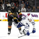 
              Vegas Golden Knights right wing Keegan Kolesar (55) knocks down Toronto Maple Leafs right wing Mitchell Marner (16) during the first period of an NHL hockey game Monday, Oct. 24, 2022, in Las Vegas. (AP Photo/Steve Marcus)
            