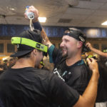 
              Seattle Mariners' Cal Raleigh, right, celebrates in the clubhouse after the team's baseball game against the Oakland Athletics, Friday, Sept. 30, 2022, in Seattle. The Mariners won 2-1 on a homer by Raleigh to clinch a spot in the playoffs. (AP Photo/Stephen Brashear)
            