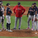 
              Cleveland Guardians manager waits with players on the mound for pitching relief during the sixth inning of Game 1 of an American League Division baseball series against the New York Yankees, Tuesday, Oct. 11, 2022, in New York. (AP Photo/Seth Wenig)
            
