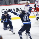 
              Winnipeg Jets' Sam Gagner (89), Logan Stanley (64) and David Gustafsson (19) celebrate Gagner's goal against the New York Rangers during the third period of an NHL hockey game Friday, Oct. 14, 2022, in Winnipeg, Manitoba. (John Woods/The Canadian Press via AP)
            