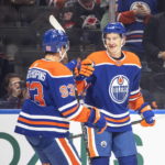 
              Edmonton Oilers' Ryan Nugent-Hopkins (93) and Ryan McLeod, right, celebrate goal against the Carolina Hurricanes during second-period NHL hockey game action in Edmonton, Alberta, Thursday, Oct. 20, 2022. (Jason Franson/The Canadian Press via AP)
            