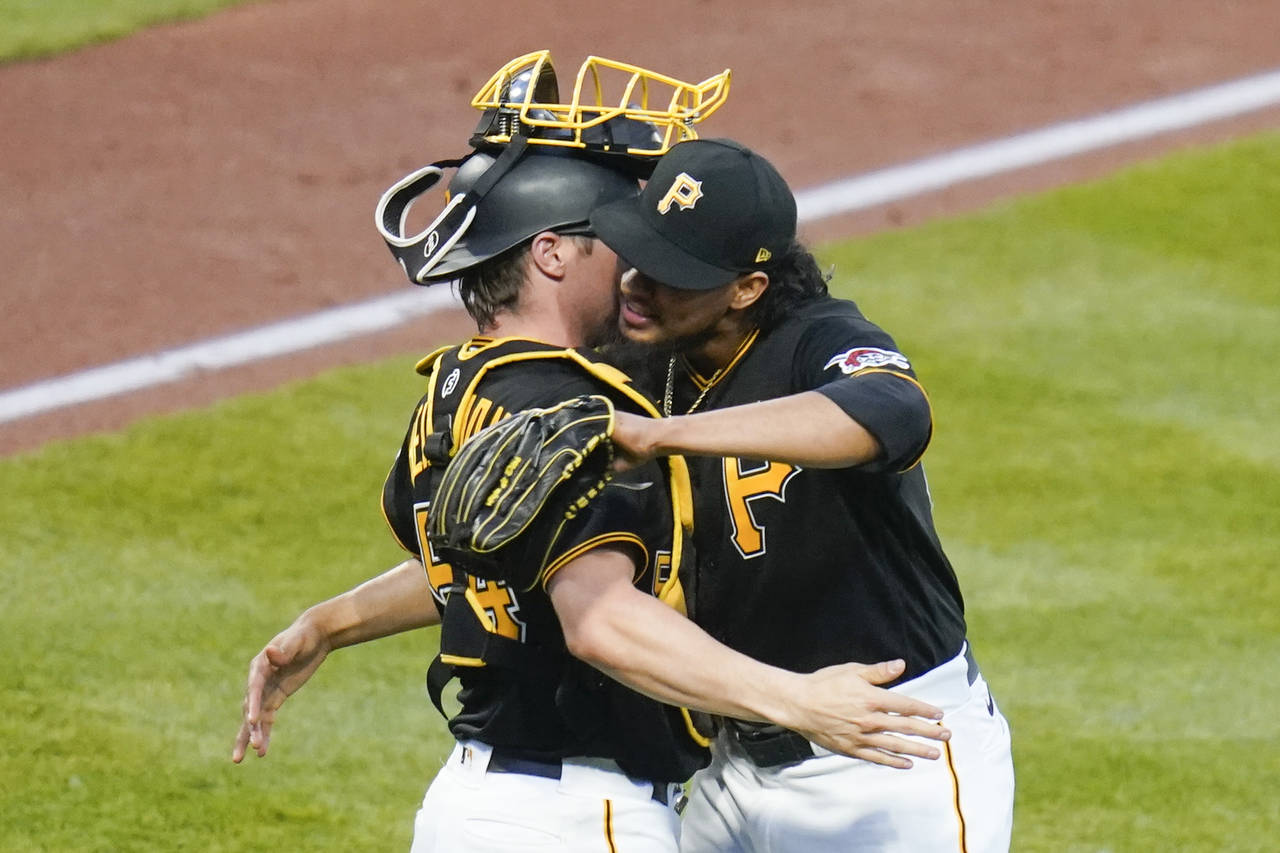 Pittsburgh Pirates relief pitcher Yohan Ramirez, right, embraces catcher Tyler Heineman after the t...