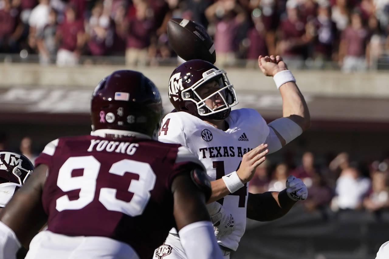 Texas A&M quarterback Max Johnson is hit from behind by a Mississippi State defender and looses the...