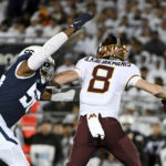 
              Penn State defensive end Amin Vanover (56) pressures Minnesota quarterback Athan Kaliakmanis (8) during the first half of an NCAA college football game Saturday, Oct. 22, 2022, in State College, Pa. (AP Photo/Barry Reeger)
            