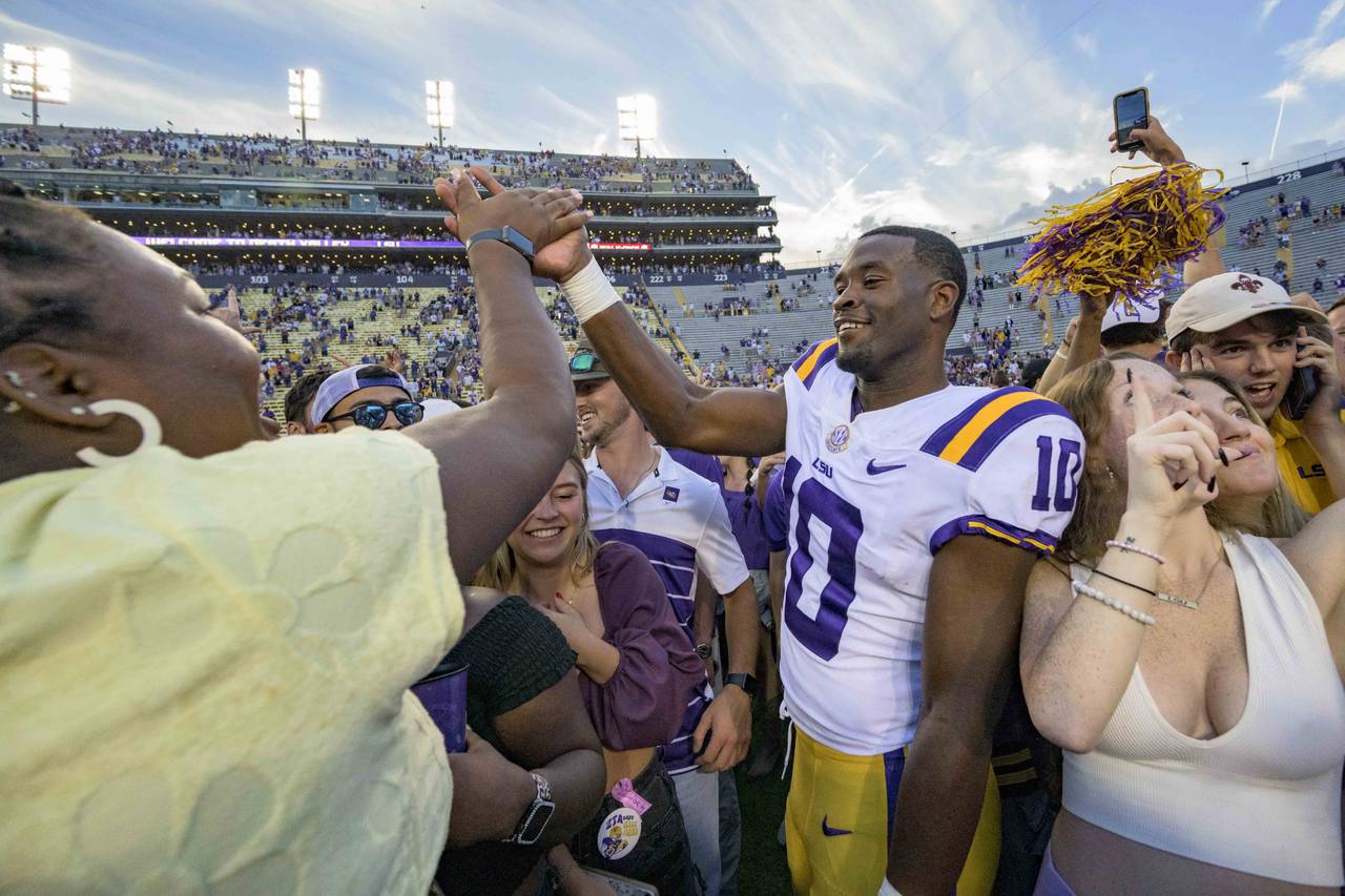LSU wide receiver Jaray Jenkins (10) celebrates with fans who came onto the field after LSU defeate...