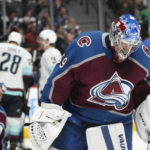 
              Colorado Avalanche goaltender Pavel Francouz, front, reacts after giving up a goal to Seattle Kraken left wing Jared McCann during the second period of an NHL hockey game Friday, Oct. 21, 2022, in Denver. (AP Photo/David Zalubowski)
            