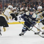 
              Columbus Blue Jackets' Zach Werenski, center, skates between Boston Bruins' Derek Forbort, left, and Brandon Carlo during the second period of an NHL hockey game Friday, Oct. 28, 2022, in Columbus, Ohio. (AP Photo/Jay LaPrete)
            