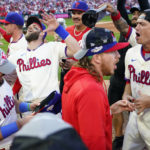 
              The Philadelphia Phillies celebrate a win over the Atlanta Braves after Game 4 of baseball's National League Division Series, Saturday, Oct. 15, 2022, in Philadelphia. The Philadelphia Phillies won, 8-3. (AP Photo/Matt Rourke)
            