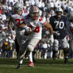 
              Ohio State defensive end J.T. Tuimoloau (44) returns an interception for a touchdown during the fourth quarter of an NCAA college football game against Penn State, Saturday, Oct. 29, 2022, in State College, Pa. Ohio State won 44-31. (AP Photo/Barry Reeger)
            