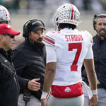 
              Ohio State head coach Ryan Day, center talks to quarterback C.J. Stroud during the first half of an NCAA college football game against Michigan State, Saturday, Oct. 8, 2022, in East Lansing, Mich. (AP Photo/Carlos Osorio)
            