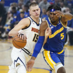 
              Denver Nuggets center Nikola Jokic (15) drives to the basket against Golden State Warriors center Kevon Looney (5) during the first half of an NBA basketball game in San Francisco, Friday, Oct. 21, 2022. (AP Photo/Jeff Chiu)
            