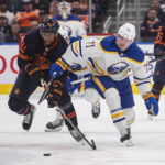 
              Buffalo Sabres' Victor Olofsson (71) and Edmonton Oilers' Evander Kane (91) race for the puck during the first period of an NHL hockey game Tuesday, Oct. 18, 2022, in Edmonton, Alberta. (Jason Franson/The Canadian Press via AP)
            