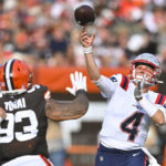 
              New England Patriots quarterback Bailey Zappe (4) throws a touchdown pass to tight end Hunter Henry (not shown) over Cleveland Browns defensive tackle Tommy Togiai (93) during the second half of an NFL football game, Sunday, Oct. 16, 2022, in Cleveland. (AP Photo/David Richard)
            