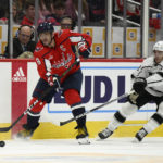 
              Washington Capitals left wing Alex Ovechkin (8) passes the puck next to Los Angeles Kings defenseman Matt Roy (3) during the first period of an NHL hockey game, Saturday, Oct. 22, 2022, in Washington. (AP Photo/Nick Wass)
            