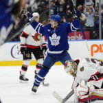 
              Maple Leafs' Alexander Kerfoot (15) celebrates a goal as Ottawa Senators goaltender Anton Forsberg (31) reacts during the second period of an NHL hockey game Saturday, Oct. 15, 2022, in Toronto. (Frank Gunn/The Canadian Press via AP)
            