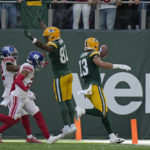 
              Green Bay Packers wide receiver Allen Lazard (13), right, celebrates after scoring a touchdown during an NFL game between the New York Giants and the Green Bay Packers at the Tottenham Hotspur stadium in London, Sunday, Oct. 9, 2022. (AP Photo/Alastair Grant)
            